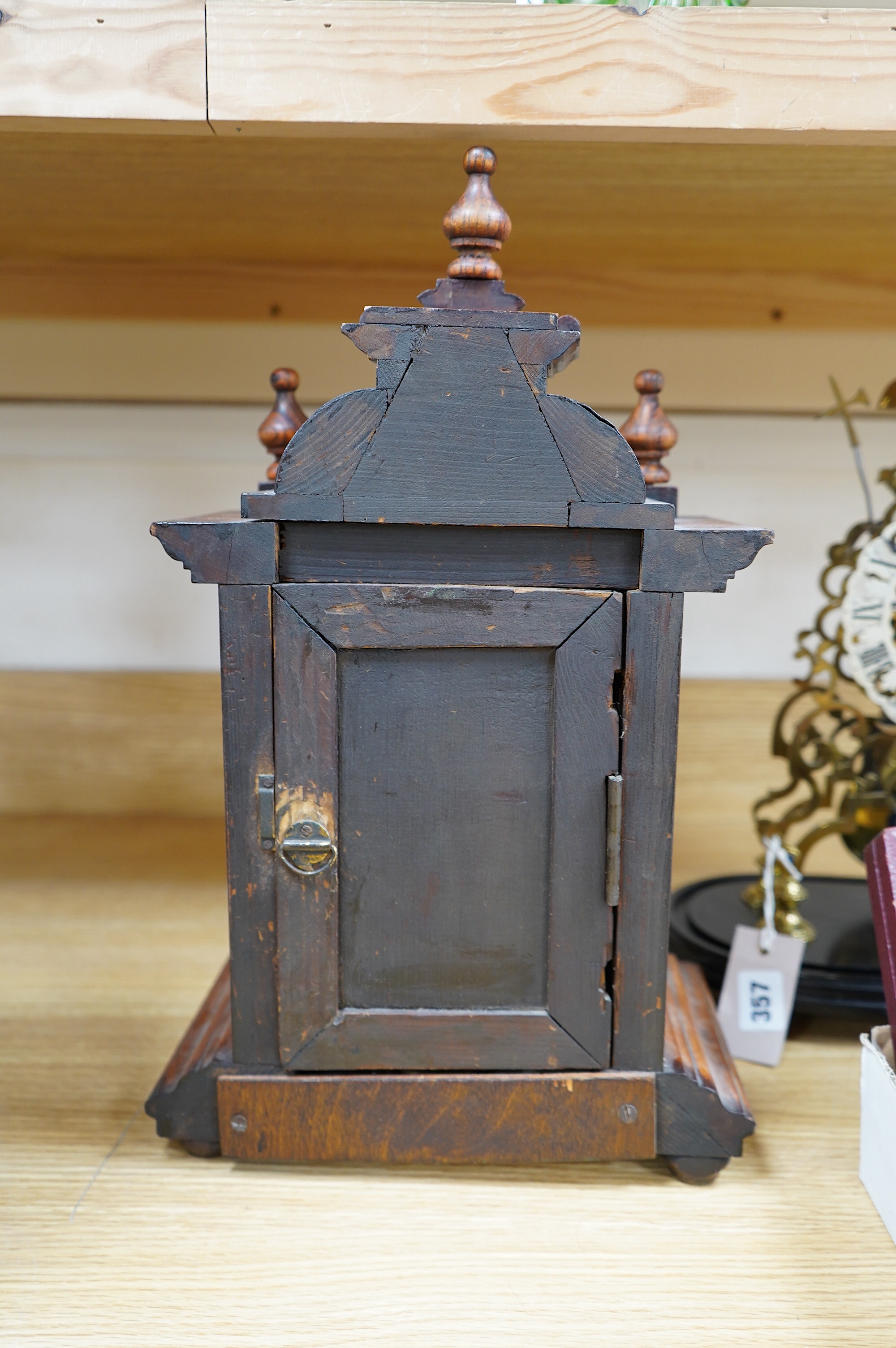 A late 19th century Black Forest walnut mantel clock with key and pendulum, 41cm. Condition - fair to good, not tested